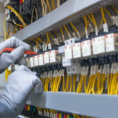 electricity-electrical-maintenance-service-engineer-hand-holding-ac-voltmeter-checking-electric-current-voltage-circuit-breaker-terminal-cable-wiring-main-power-distribution-board